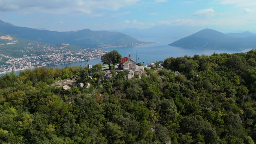 Stunning drone flight over the entrance of the Bay of Kotor in Montenegro, with panoramic view of mountains and the Lustica peninsula.