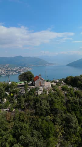 Drone footage showing the Adriatic coastline, mountain slopes, and the open sea near Herceg Novi, Montenegro.