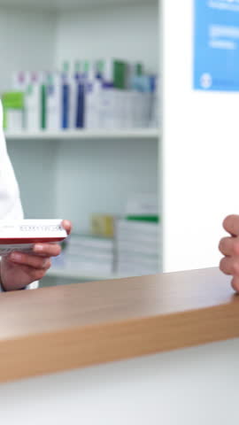 Medication, hands and pharmacist with customer at pharmacy with explaining side effects. Medicine, discussion and chemist with person for dosage instructions on pill box at dispensary in drug store.