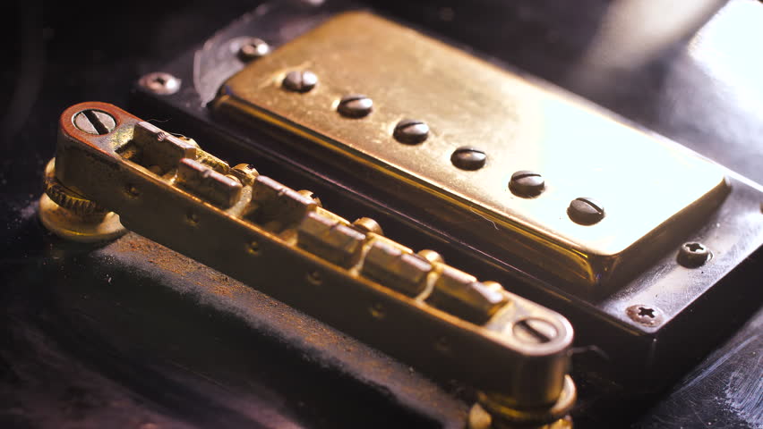 Close up shot the hand using microfiber fabric to clean the fret board of electric guitar