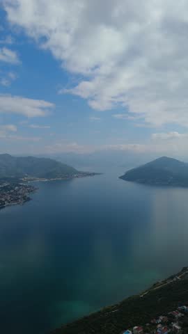 Drone flying above the entrance to the Bay of Kotor — scenic view of the Adriatic coast and mountains in Montenegro.