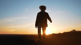 Farmer walking through field at sunset. Organic agriculture practices on farm. lifestyle in organic farming. Farmer inspecting crops in scenic sunset. agriculture scene. Farmer agriculture organic. - Powered by Shutterstock - Get 15% off with code: PIKWIZARD15