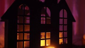 A dark Halloween night unveils a castle silhouette lit by flickering candlelight. Shadows dance across the windows, evoking a sense of fear and mystery. Flickering candlelight bursts through windows - Powered by Shutterstock - Get 15% off with code: PIKWIZARD15