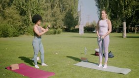 Two women exercising outdoors, one jumping rope while the other watches with a phone - Powered by Shutterstock - Get 15% off with code: PIKWIZARD15