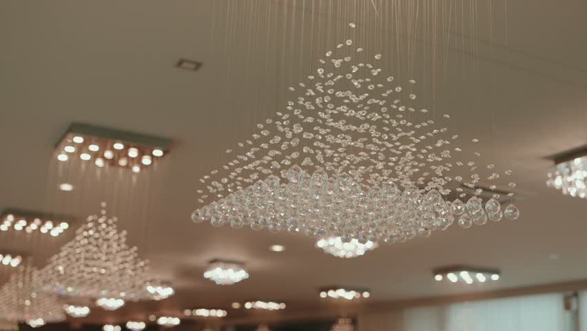 Sparkling crystal chandeliers lighting up a modern event hall