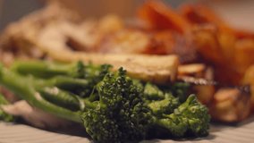 Moving View Over British Roast Lunch with Close Up Details Broccoli, Parnsips, Golden Potatoes. Classic British Cuisine Food. - Powered by Shutterstock - Get 15% off with code: PIKWIZARD15