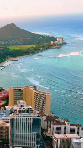 Aerial view of Waikiki Beach in Honolulu, Oahu. Turquoise ocean, and Diamond Head crater create a classic Hawaiian scene. Vertical video.