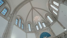 Upward view of elegant church dome with stained glass windows and chandelier inside a historic chapel - Powered by Shutterstock - Get 15% off with code: PIKWIZARD15