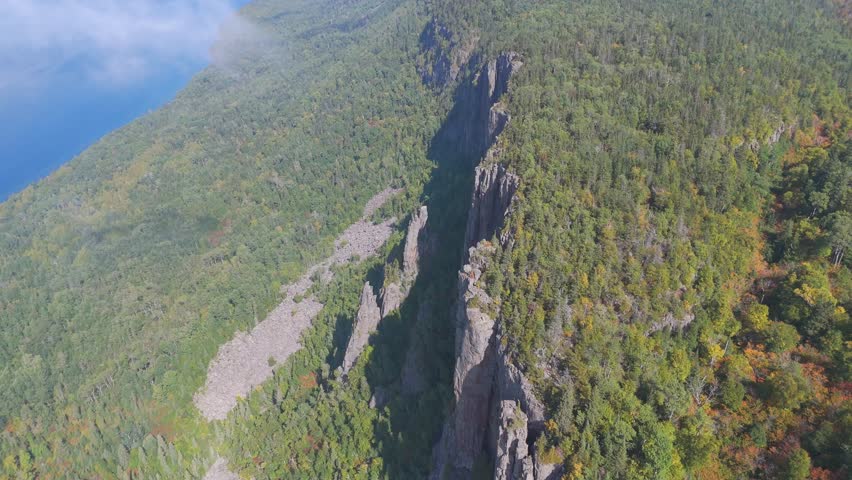 A stunning view of the towering cliffs at Sleeping Giant, Ontario, surrounded by dense green forest