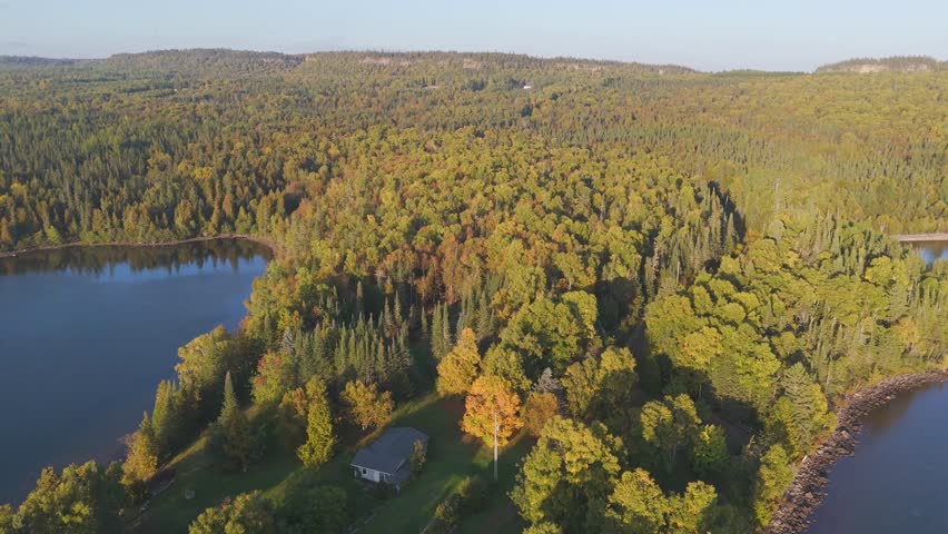 Warm sunset light over the forest by Laken Superior shoreline in Ontario, Canada
