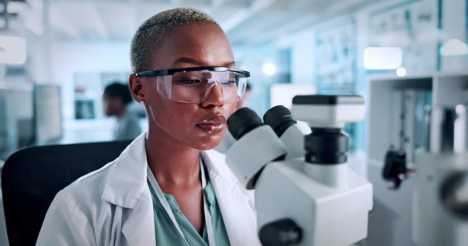 Woman, scientist and microscope analysis at lab with test process, review or pharmaceutical study. Person, medical research and tools for vaccine development, drugs or solution with cure for virus