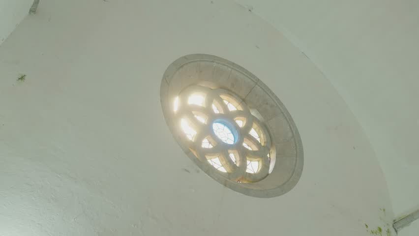 Warm sunlight filtering through an ornate circular stained glass window inside an old church - Powered by Shutterstock - Get 15% off with code: PIKWIZARD15