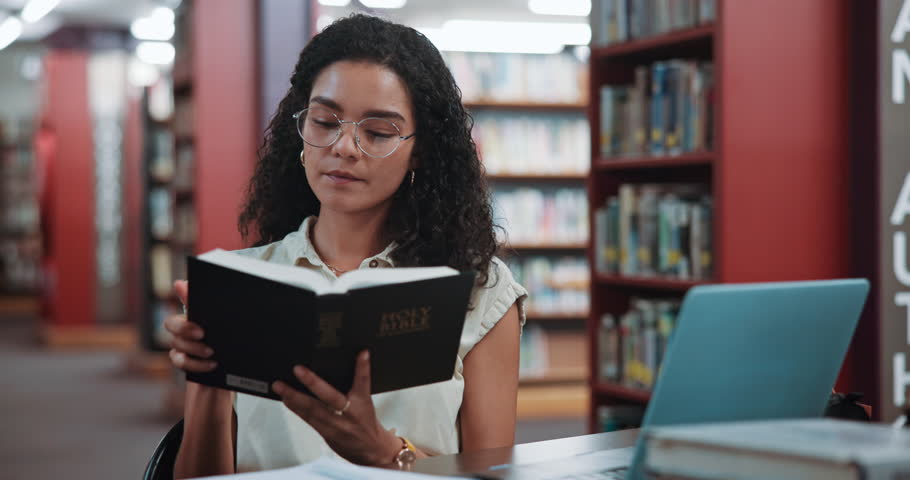 Library, knowledge and woman with bible, reading and personal devotion with scripture and religious. Learning, theology and person with holy book for spiritual guidance, belief and faith in Jesus