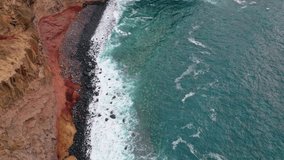 Stormy ocean crashing stone beach aerial view. Picturesque blue waves foaming at rocky shoreline. Breathtaking sea water splashing on rough coastal cliffs. Beautiful tide rolling on rugged shore. - Powered by Shutterstock - Get 15% off with code: PIKWIZARD15