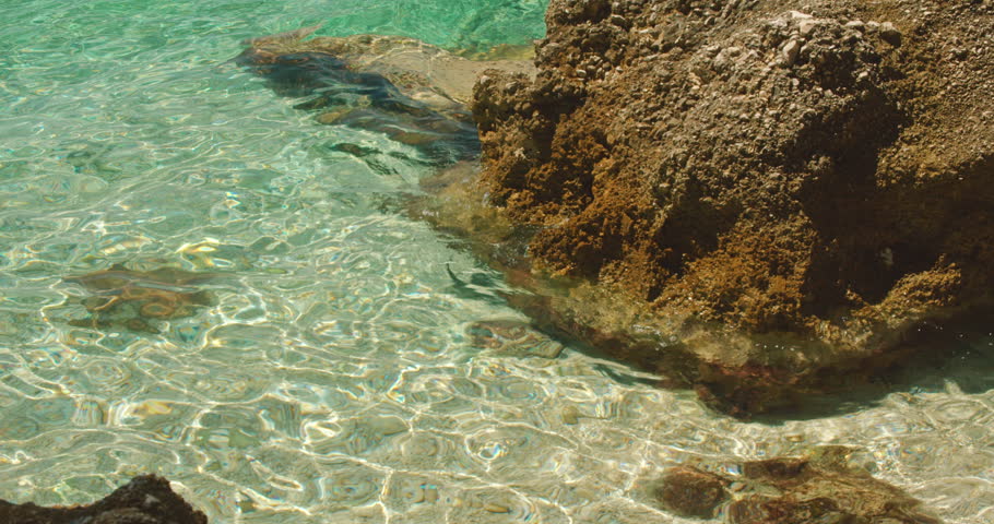 Close-up of crystal clear turquoise sea water and rocks in Makarska, Croatia