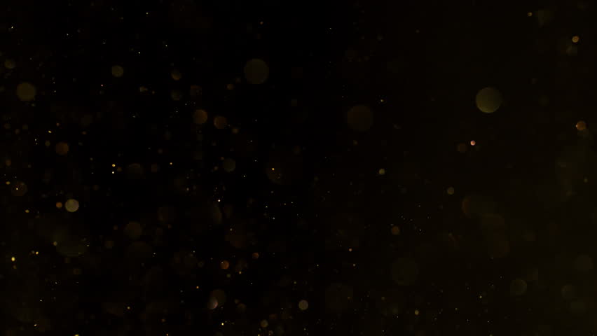 Super Slow Motion Shot of Golden Glitters Isolated on Black at 1000fps.
