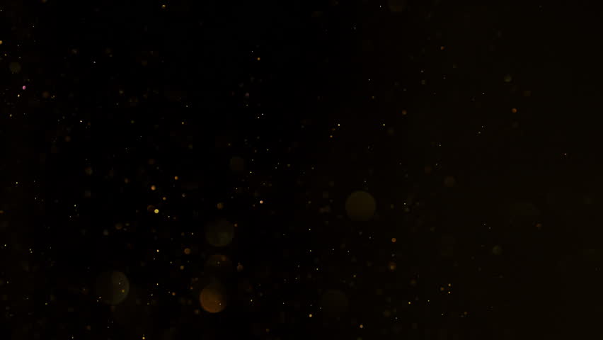 Super Slow Motion Shot of Golden Glitters Isolated on Black at 1000fps.