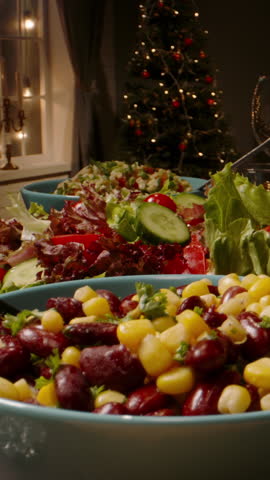 Vertical video camera sliding along table with vegetarian salad made of beans and corn concept healthy food thanksgiving dinner christmas feast family celebration organic lifestyle holiday mood