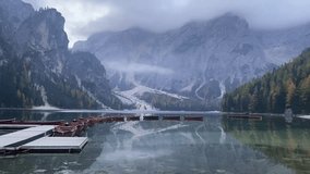 Serene morning view of wooden boats on Lake Braies with misty Dolomites - Powered by Shutterstock - Get 15% off with code: PIKWIZARD15