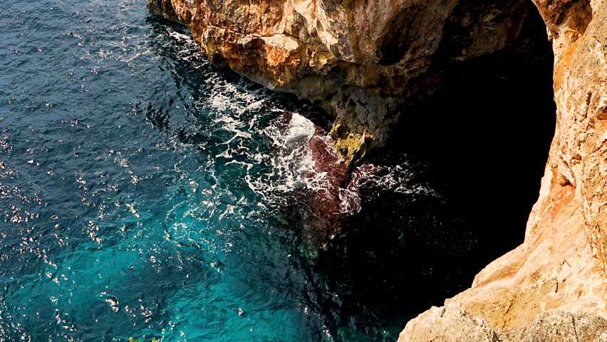 Aerial view of turquoise Mediterranean sea along rocky coast of Mallorca, Spain. Stunning coastal landscape perfect for travel and nature projects.