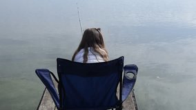 A little girl fishing with a fishing rod on an autumn pond - Powered by Shutterstock - Get 15% off with code: PIKWIZARD15