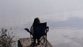 A little girl fishing with a fishing rod on an autumn pond - Powered by Shutterstock - Get 15% off with code: PIKWIZARD15