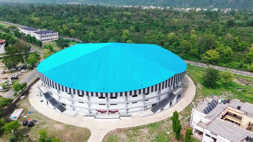 Sports Stadium Surrounded by Trees – Aerial Drone Shot