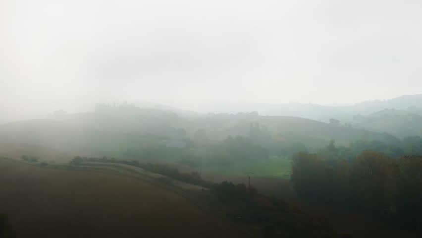 Fast Drone Track Right Over Greenhouses in Mist, Hills Swallowed by Heavy Fog