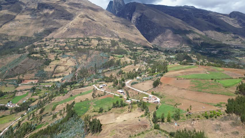 Huaraz, Peru: Drone footage of the road heading to Laguna Paron in Huaraz, Peru. Taken with tilt up motion featuring dramatic valley under cloudy sky
