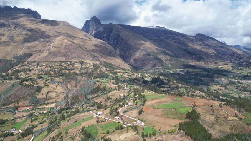 Huaraz, Peru: Drone footage of the road heading to Laguna Paron in Huaraz, Peru. Taken with orbit motion featuring dramatic valley under cloudy sky