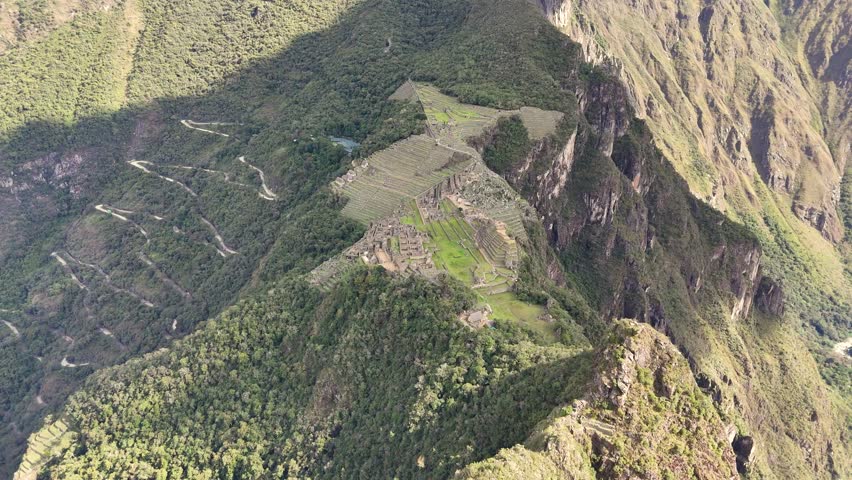From peak of Huayna Picchu, moves towards Machu Picchu, into a close-up: Nusta