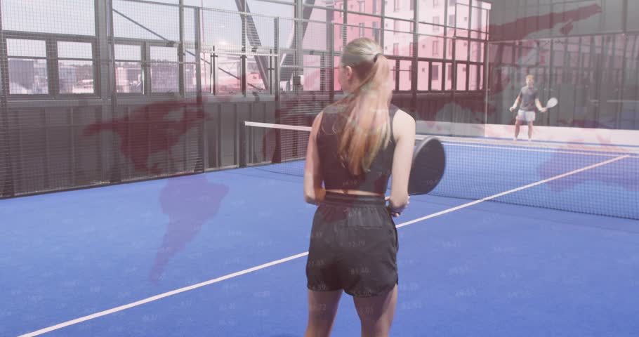 Woman tossing ball and serving sports padel shot, man returning, partners shifting for next rally. Action, sport, recreation, urban, fitness, engaging, competitive