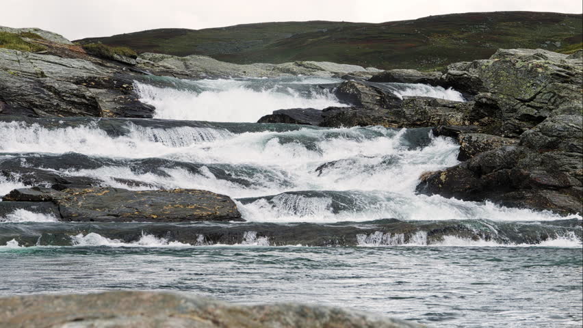 Rapid river water flowing over rocky cascades in the Scandinavian mountain wilderness of Stekenjokk, Sweden, a powerful and pristine natural landscape along the Wilderness Road