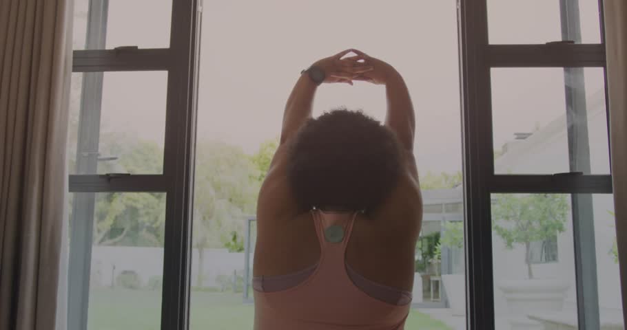 Woman raising interlaced arms initiating data chart for fitness tracking, glitching in stretching. Exercise, wellness, technology, digitalart, health, fitness, motion