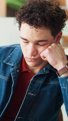 Unhappy, employee and man in office, tired and journalist with low energy, think and bored with job. Frustrated, reporter and person with burnout in newsroom, reflection and lazy with exhaustion