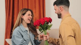 A cheerful woman happily accepts a stunning bouquet of red roses from her affectionate partner, symbolizing love. The warm colors enhance the intimate moment, showcasing their emotional connection. - Powered by Shutterstock - Get 15% off with code: PIKWIZARD15