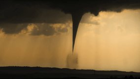 A dark tornado spins violently beneath black storm clouds and heavy rain, showcasing the raw intensity, motion, and destructive power of severe weather in dramatic detail - Powered by Shutterstock - Get 15% off with code: PIKWIZARD15