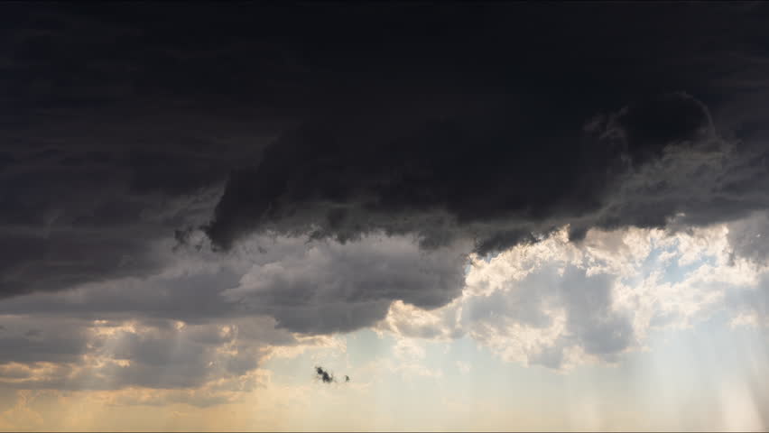 A moody sky turns golden as the storm fades, revealing soft light, shifting clouds, and the tranquil beauty of nature transitioning from turmoil to calm daylight