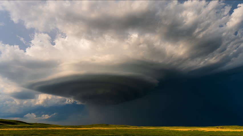 A powerful supercell rotates beneath dramatic cloud formations, revealing intense atmospheric motion, vivid texture, and the awe-inspiring energy of severe weather in action