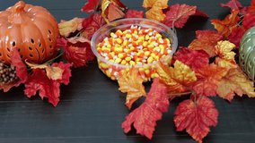Man Eating Candy Corn for Halloween in Fall at Festive Dinner Table in Dark Wood - Powered by Shutterstock - Get 15% off with code: PIKWIZARD15