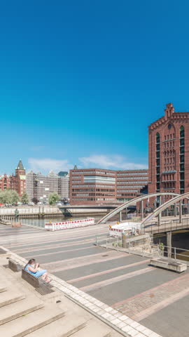 Panorama showing famous old Speicherstadt in Hamburg timelapse featuring the International Maritime Museum, iconic brick buildings, arch bridges, canals and waterfront. A historic landmark in Germany