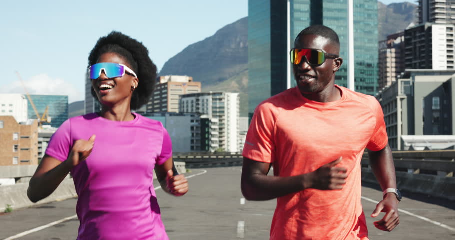 Fitness, running and black couple on bridge in city for health, training or wellness together for bonding. Sports, talking and African man with woman for cardio exercise or workout in urban town.
