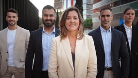 A diverse group of confident business professionals stands together outdoors, looking at the camera with determination and poise, dressed in smart attire, showcasing teamwork and unity in a modern - Powered by Shutterstock - Get 15% off with code: PIKWIZARD15