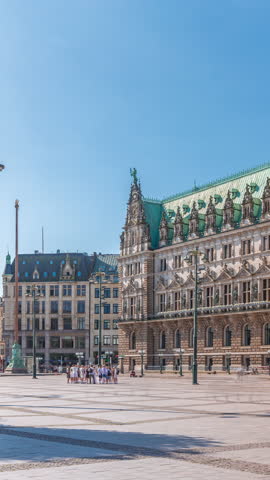 Building of the Hamburg City Hall timelapse, the seat of the government of Hamburg, located in the Altstadt quarter in the city center. Front view from the main square under a blue clear sky