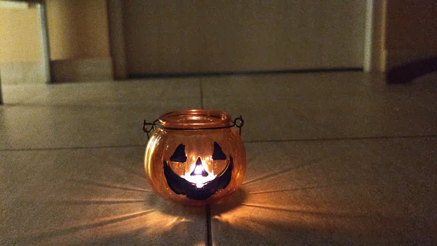 A pumpkin candlestick in a man