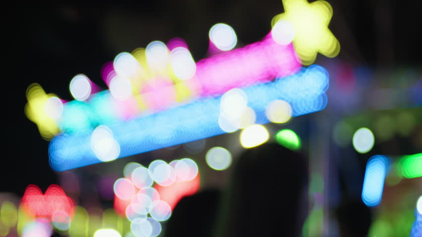 Bright Lights of a Ferris Wheel at Night in the City