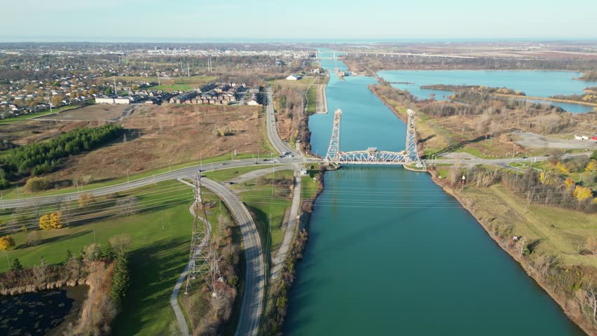 Aerial over the Welland Canal, part of the St. Lawrence Seaway and Great Lakes Waterway in St. Catharines, Ontario, Canada. Moving forward north over the Glendale Avenue Lift Bridge on towards lock 3.