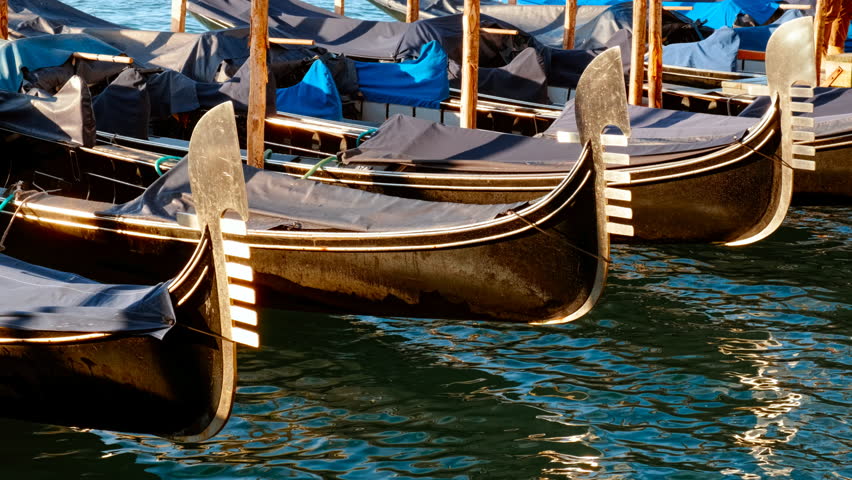 Empty gondolas at the Riva degli Schiavoni monumental waterfront in Venice, Italy. Venice is an archipelago of 126 islands linked by 472 bridges
