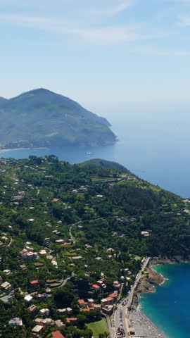 Vertical drone shot approaching the Levanto town, sunny day in Liguria, Italy