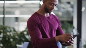 Male pro tapping smartphone in office generating clear tech icons for app functions. Innovation, connectivity, modernity, digital, professional, technology, interface - Powered by Shutterstock - Get 15% off with code: PIKWIZARD15